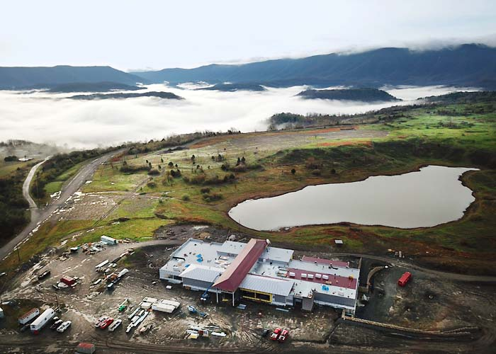 Aerial view of the Boone's Ridge destination site with surrounding mountains and a lake